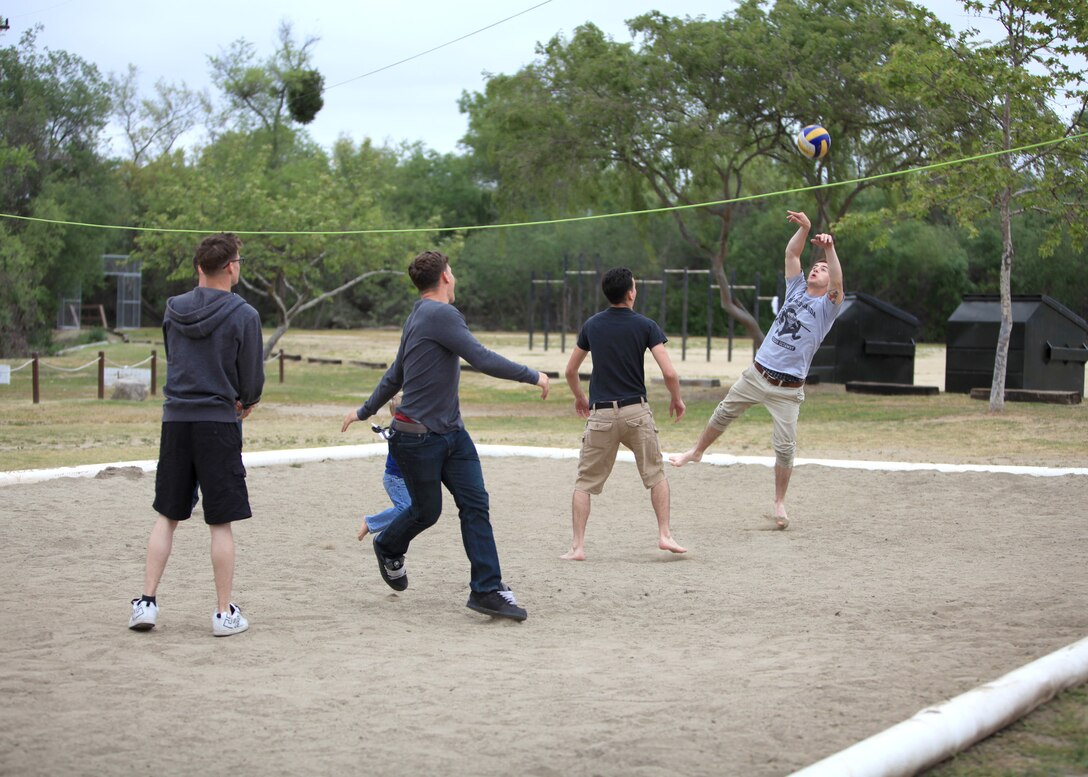 Marines with Alpha Company, 1st Radio Battalion, I Marine Expeditionary Force, play volleyball during a family day event for the company at Camp Pendleton, Calif., April 5. 