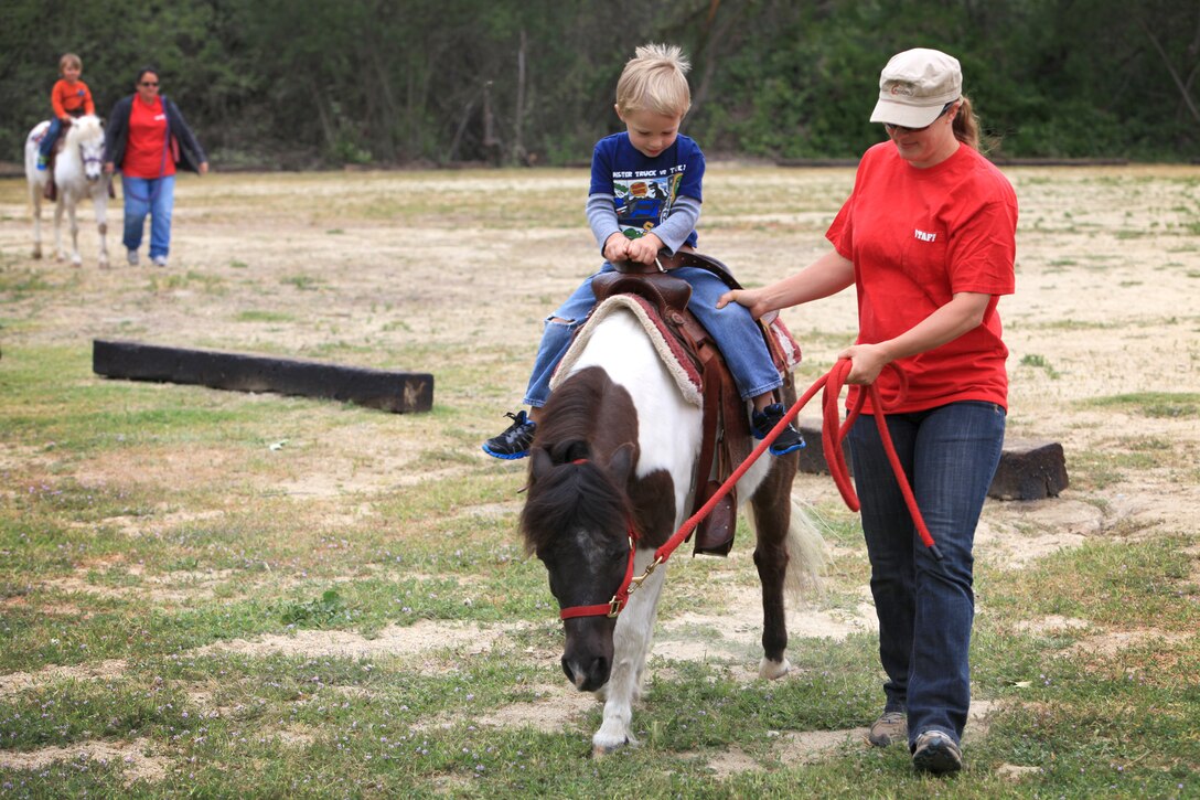 Emerson Dessert, 3, from New Smyrna Beach, Fla., rides a pony during a family day event for Alpha Company, 1st Radio Battalion, I Marine Expeditionary Force, at Camp Pendleton, Calif., April 5. Emerson is the son of Cpl. Gregory Dessert, a cryptologic linguist.
