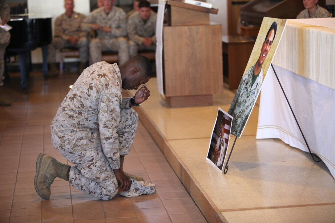 Lt. Col. Ahmed Williamson, the commanding officer of 9th Communication Battalion, I Marine Expeditionary Force, pays his respect to Petty Officer 2nd Class Pasquale Troisi during his memorial service at Camp Pendleton, Calif., April 9. Troisi, 31, from Abington, Pa., died of complications from 2nd and 3rd degree burns sustained while on leave in Philadelphia, March 18. Troisi recently returned from a deployment to Afghanistan.
