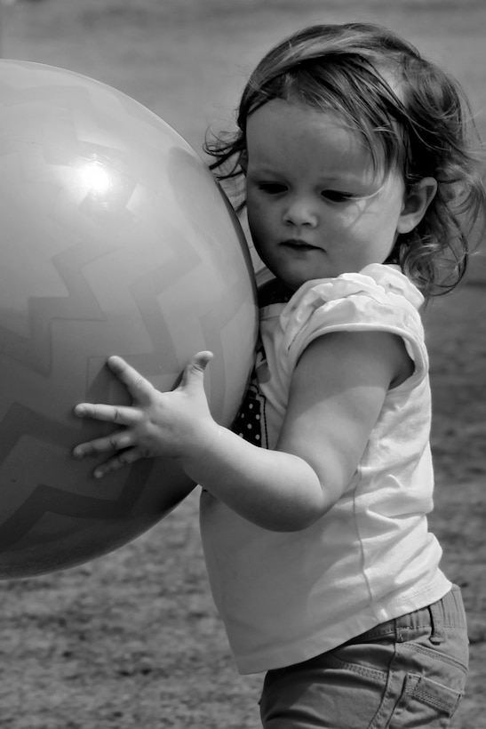 Emma Kendrick, 2, daughter of Capt. Matthew Kendrick, company commander, Maintenance Services Company, Combat Logistics Battalion 7, plays during the unit's field meet and family day events at Del Valle Field March 28, 2013.
