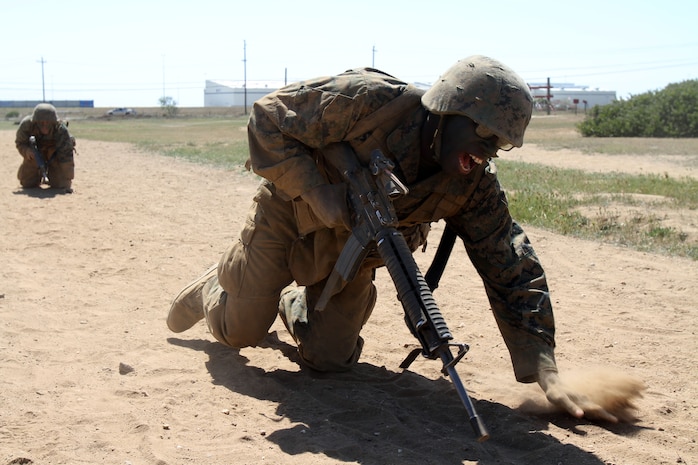 Pvt. Jeremiah Owens, Platoon 3242, Company L, 3rd Recruit Training Battalion high-crawls during a Crucible event at Edson Range aboard Marine Corps Base Camp Pendleton, Calif. Owens was inspired and driven by the adveristy he faced growing up.