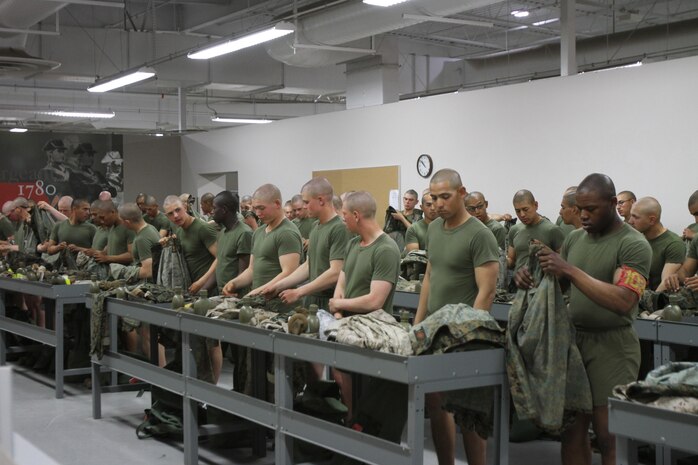 Recruits of Company B, 1st Recruit Training Battalion, turn in their camouflage utilities to have their name tapes sewn onto them aboard Marine Corps Recruit Depot San Diego March 29. The uniform fitting is also held to ensure recruits are correctly sized for their dress uniforms.