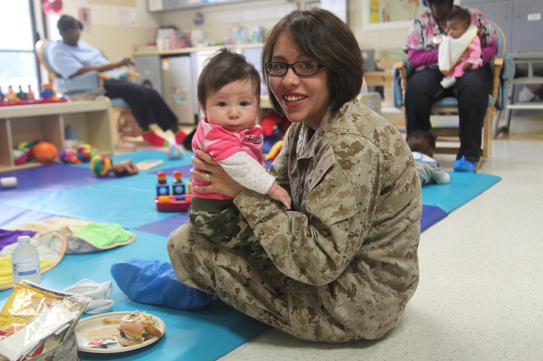 Cpl. Maria Cognac, a personal administrator with Headquarters and Headquarters Squadron, spends time with her four-month-old daughter Lea Cognac during the Month of the Military Child picnic at the Child Developement Center at Marine Corps Air Station Beaufort, April 1. This month recognizes the sacrifices military children make and struggles they go through as their parents serve our country. 