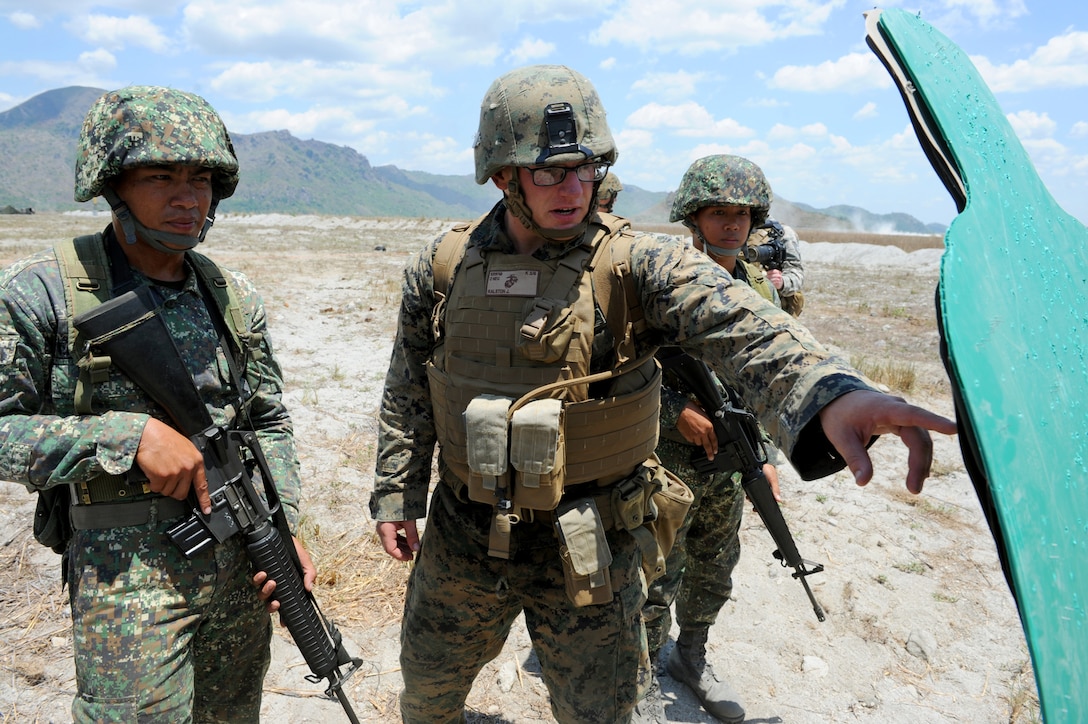 U.S. Marine infantryman Staff Sgt. Joshua Morris, a Colorado native, discusses the impacts on a target April 7 with Philippine Marine Staff Sgt. Donald Bucayo, a native of Cagayan Valley, during a bilateral live-fire drill at a firing range in Crow Valley, Philippines, as part of Balikatan 2013. BK13 is an annual bilateral training exercise that facilitates interoperability between Philippine and U.S. military forces across a wide range of military actions. Bucayo is with Inshore Boat Battalion, Philippine Marine Corps, and Morris is with Kilo Company, 3rd Battalion, 6th Marine Regiment, 2nd Marine Division.