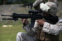 Gunnery Sgt. Patricio A. Mora fires the M-27 “Infantry Automatic Rifle” March 4 on an NCTS range during Exercise Guahan Shield.  The IAR design is based off of the M16 and M4 rifles service members have become familiar with.  Guahan Shield will facilitate multiservice engagements, set conditions for bilateral and multilateral training opportunities, and support rapid response to potential theatre crises and contingency operations in the Asia-Pacific region.  Mora is a Supply Chief with 3rd Marine Logistics Group, III Marine Expeditionary Force assigned to the Forward Command Element, 3rd MLG, III MEF as Logistics Chief for Guahan Shield. 