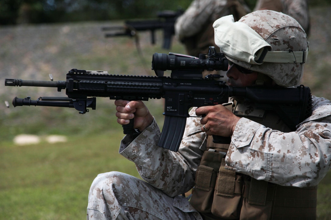 Gunnery Sgt. Patricio A. Mora fires the M-27 “Infantry Automatic Rifle” March 4 on an NCTS range during Exercise Guahan Shield.  The IAR design is based off of the M16 and M4 rifles service members have become familiar with.  Guahan Shield will facilitate multiservice engagements, set conditions for bilateral and multilateral training opportunities, and support rapid response to potential theatre crises and contingency operations in the Asia-Pacific region.  Mora is a Supply Chief with 3rd Marine Logistics Group, III Marine Expeditionary Force assigned to the Forward Command Element, 3rd MLG, III MEF as Logistics Chief for Guahan Shield. 