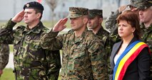 Lt. Col. Steve Wolf (center), Col. Ioan-Duru Apafaian (left) stand with Mihal Kogalniceanu mayor, Mrs. Belu Ancuta (right) during the opening ceremony at Mihal Kogalniceanu, Romania.  Marines and sailors with Black Sea Rotational Force 13 hold an opening ceremony to welcome BSRF-13 to M.K., Romania, April 10, 2013.  BSRF-13 will be based  out of M.K. and from there they will travel to 21 diffrent countries to promote regional security and engage our partner military forces.