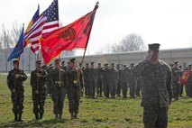 Capt. Nicholas Vogel presents a salute during the opening ceremony at Mihal Kogalniceanu, Romania.  Marines and sailors with Black Sea Rotational Force 13 hold an opening ceremony to welcome BSRF-13 to M.K., Romania, April 10, 2013.  BSRF-13 will be based  out of M.K. and from there they will travel to 21 diffrent countries to promote regional security and engage our partner military forces.