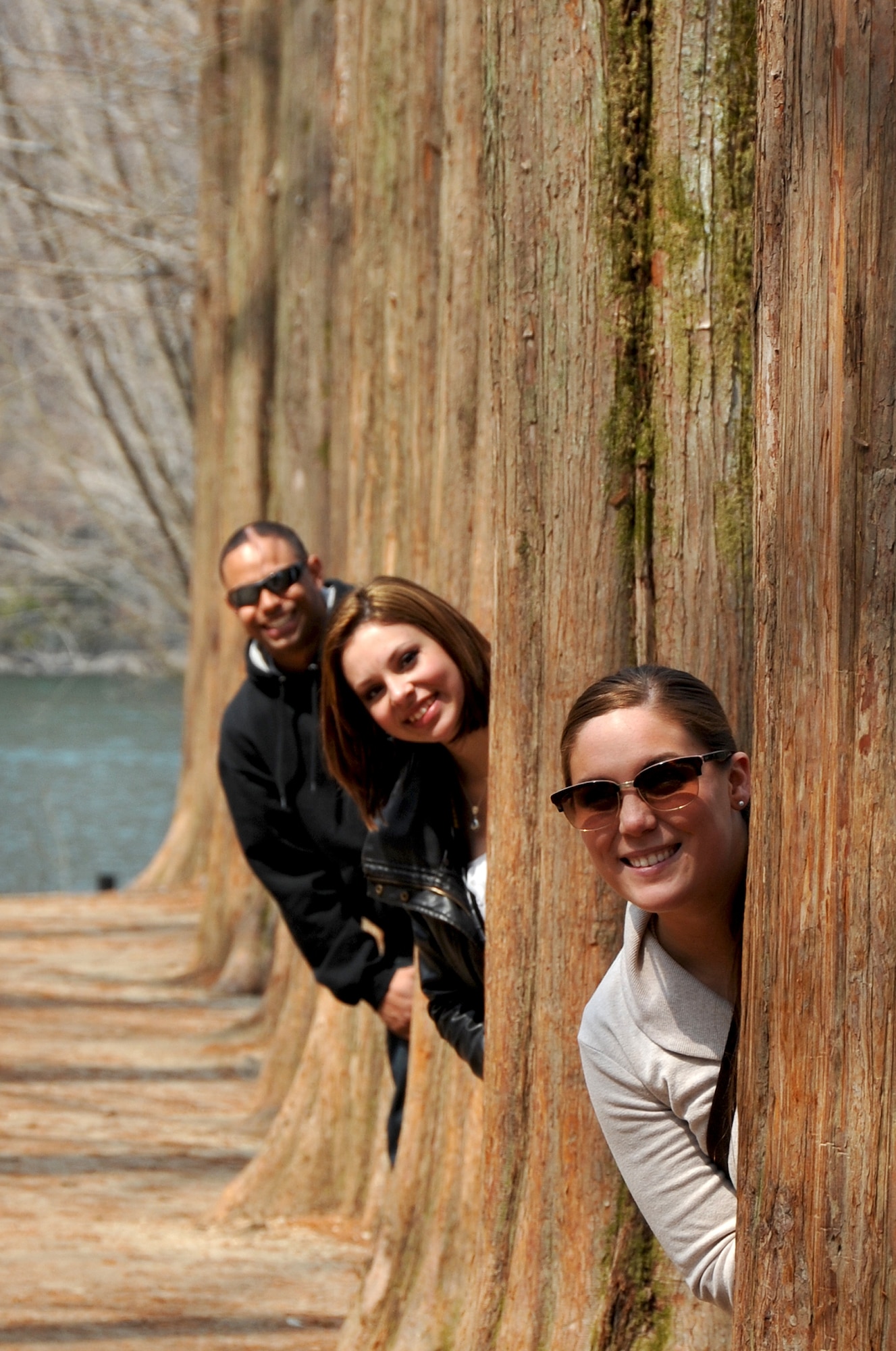 Senior Airman Samantha Konciezny, 51st Fighter Wing Public Affairs broadcaster, Airman 1st Class Dakota Allen, 5th Reconnaissance Squadron member, and Tech Sgt. Noah Moore, 51st Maintenance Squadron unit deployment manager, enjoy the natural wonders at the renowned Metasequoia path at Nami Island April 8, 2013. The path was one of the locations used during the filming of a "Winter Sonata,” a Korean drama that was part of the 'Korean Wave', the international popularity of Korean arts and entertainment. (U.S. Air Force photo/Senior Airman Kristina Overton)