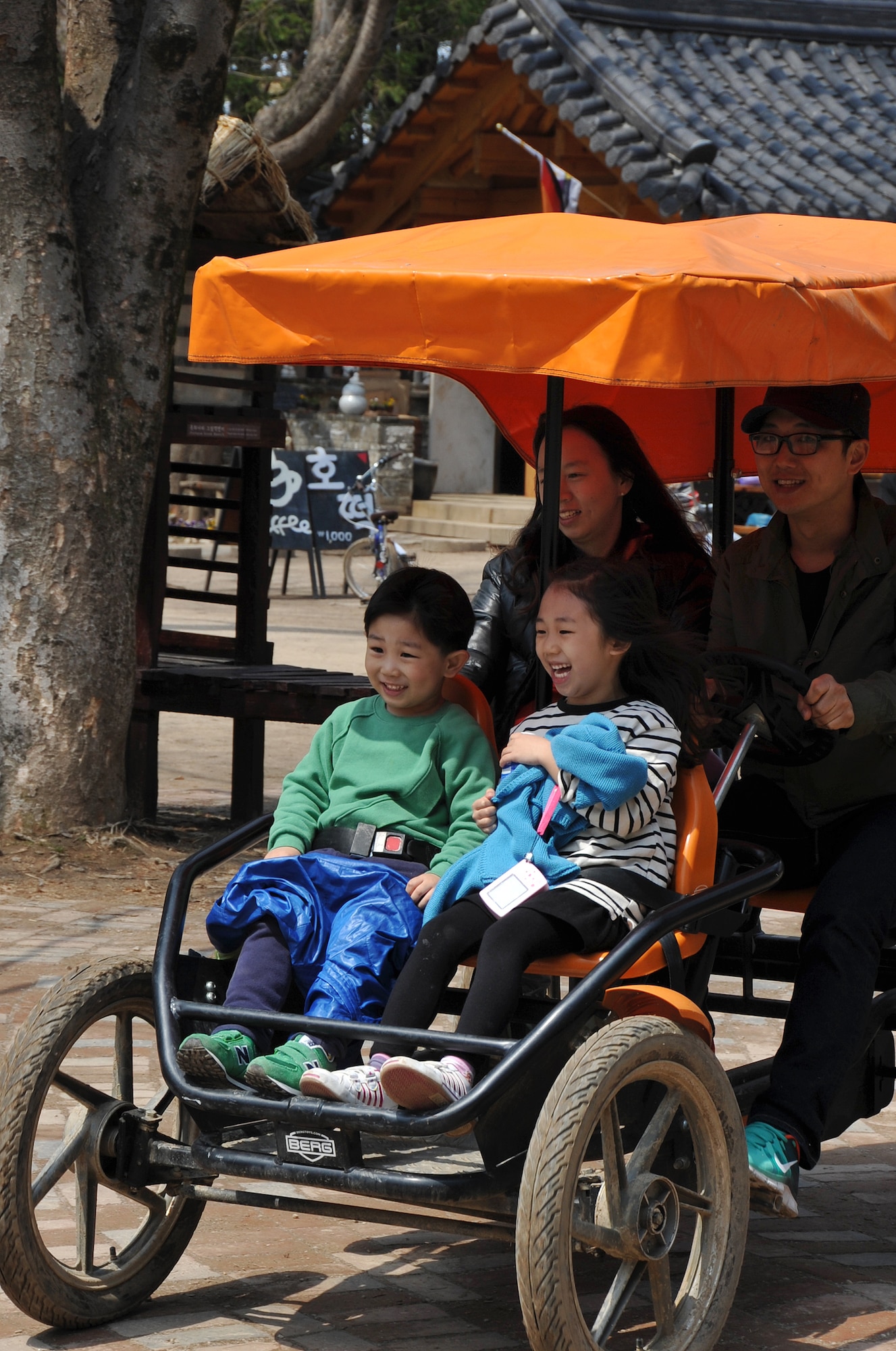 A Korean family enjoys an afternoon driving around Nami Island, Republic of Korea, in their four-person electric car April 8, 2013. The island has single, tandem or family bicycles, electric cars and electric tricycles available for rent. (U.S. Air Force photo/Senior Airman Kristina Overton)