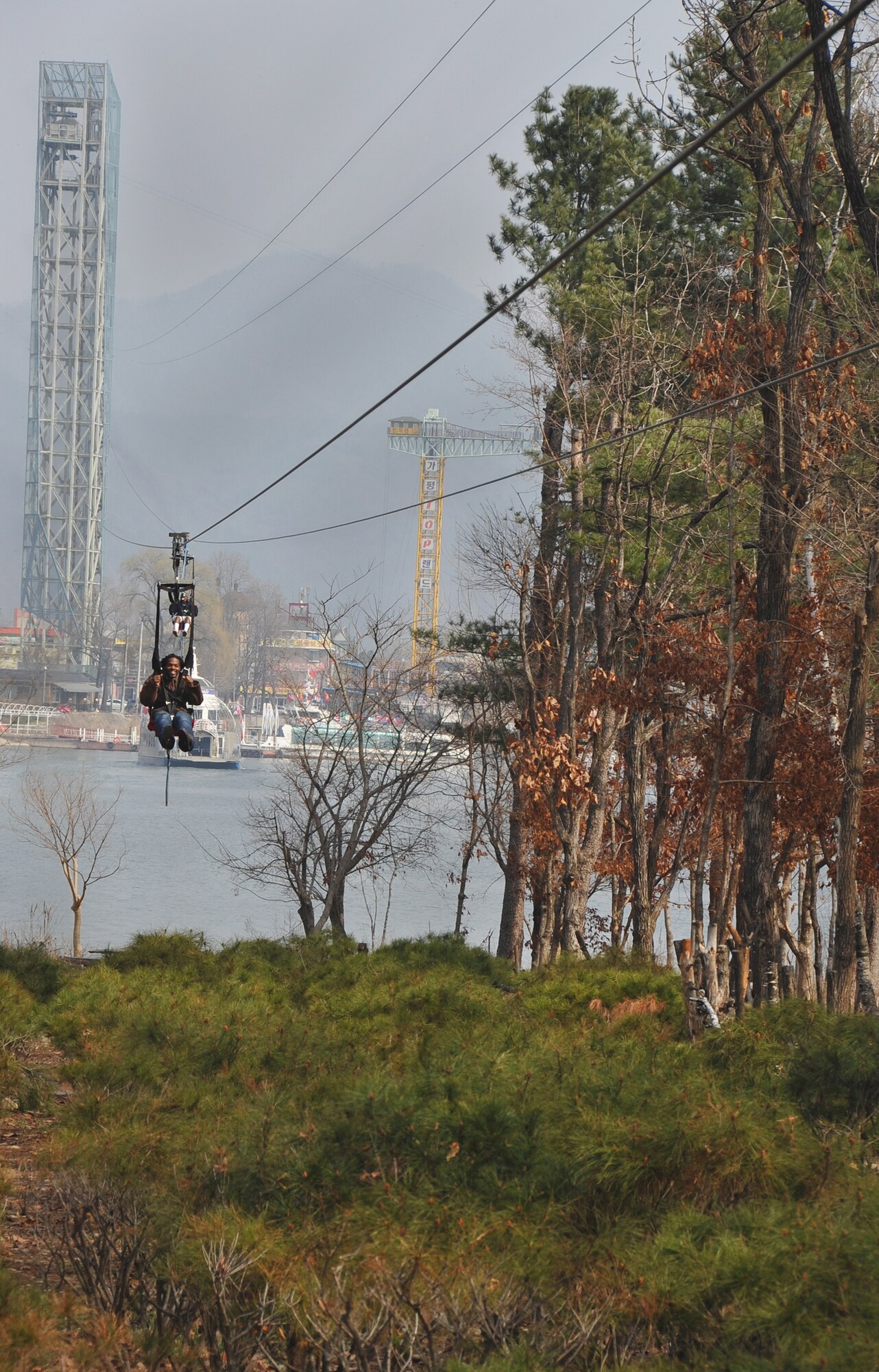 Two Nami Island visitors, zip line into the Island April 8, 2013.  This is one of two ways guests can make their way down to the entry pier of Nami Island. Nami Island is only two hours from Osan Air Base. (U.S. Air Force photo/Senior Airman Kristina Overton)