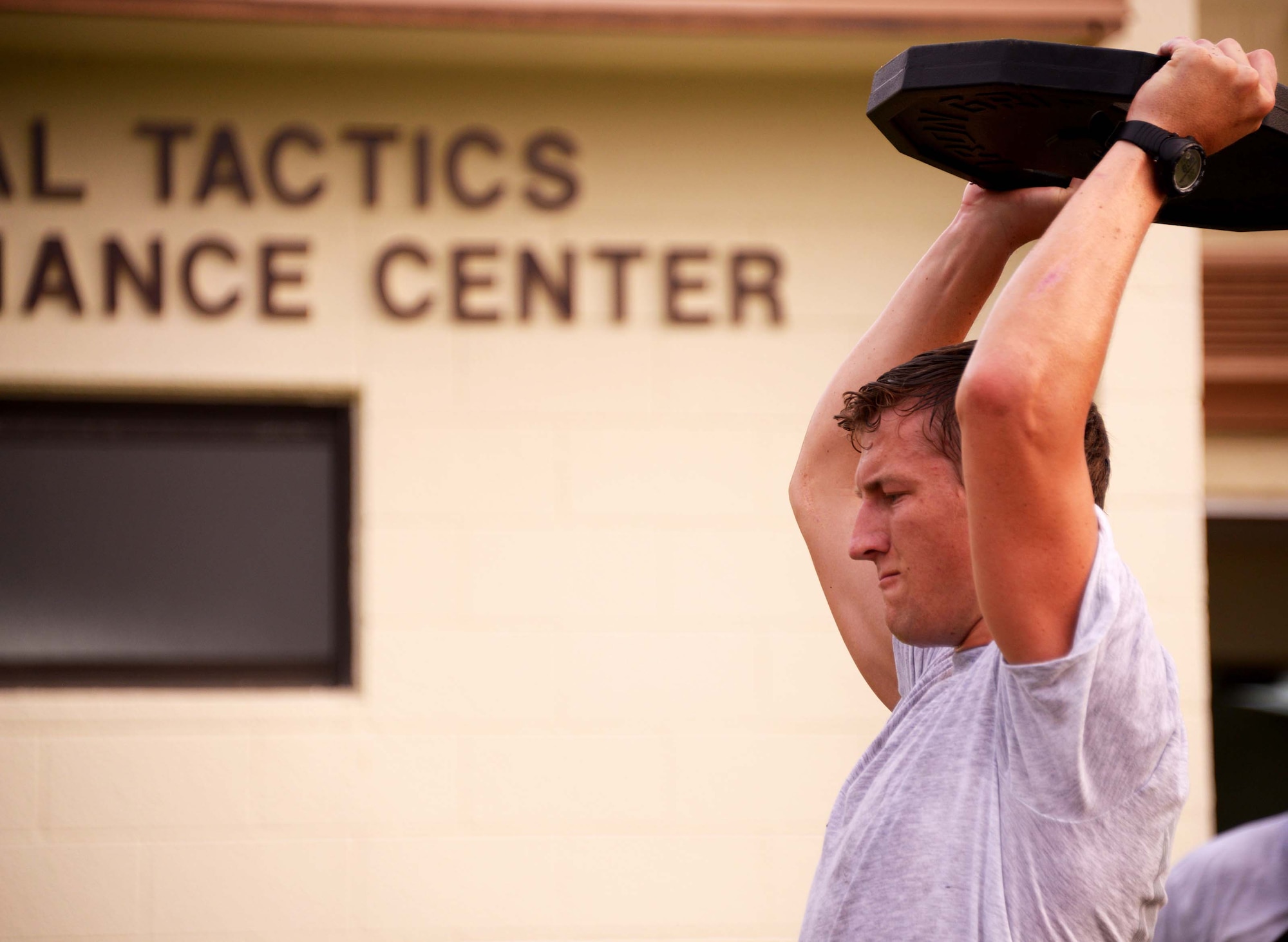 Senior Airman Keaton Thiem, 320th Special Tactics Squadron, works out in front of Human Performance Training Center, during squadron physical training March 22 at Kadena Air Base, Japan.  The HPTC houses the human performance program, which focuses on not only strengthening the battlefield Airman physically, but also rehabilitating the individual ensuring the Air Force’s human weapons system is performing to its maximum potential for as long as possible.  (U.S. Air Force photo by Tech. Sgt. Kristine Dreyer)