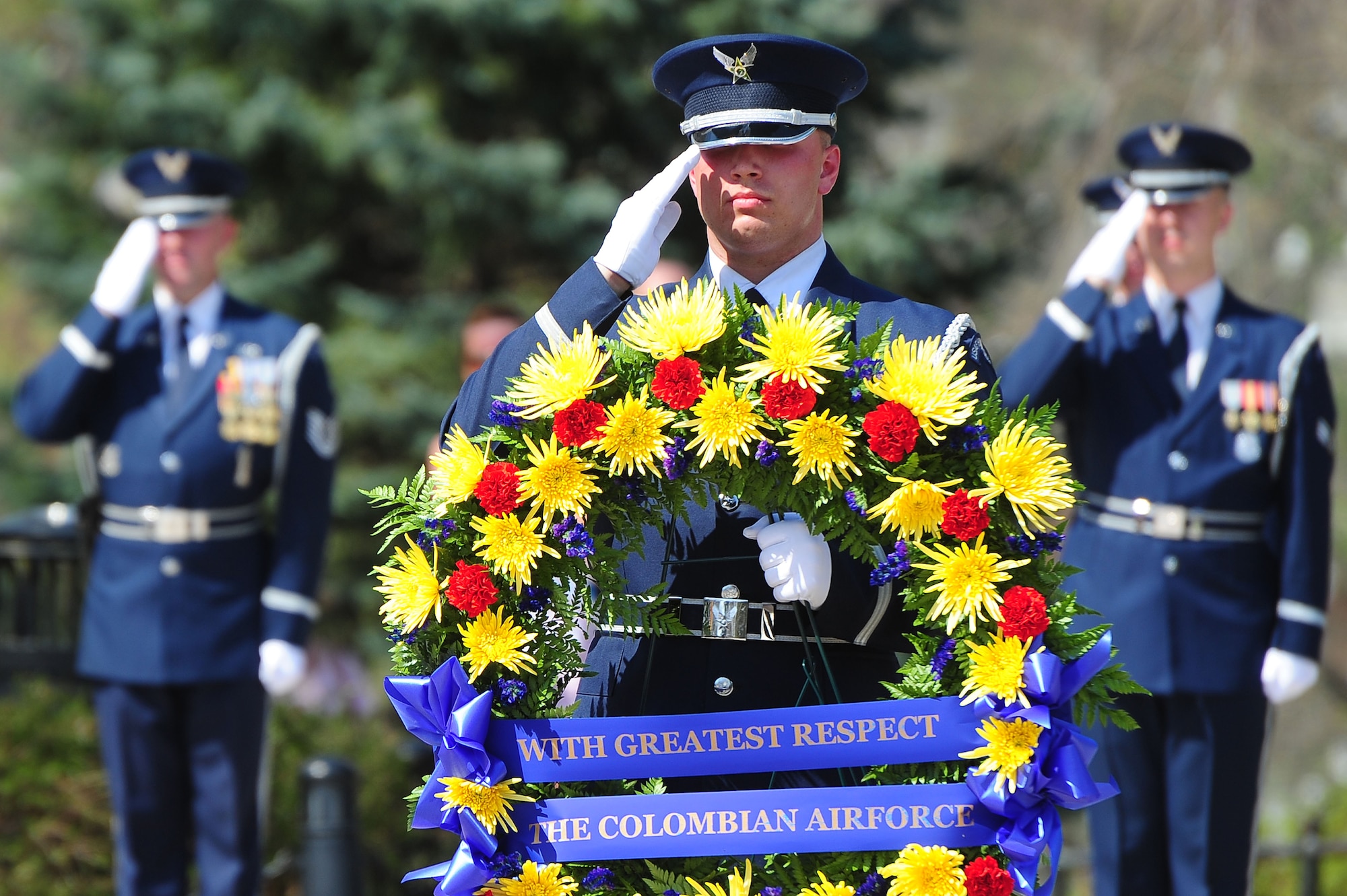 U.S. Air Force Honor Guardsmen honor members of the Columbian Air Force during a wreath laying ceremony at the Tomb of the Unknown Soldier, April 9, 2013, in Arlington, Va. Air Force District of Washington leadership and members of the U.S. Air Force Band and Honor Guard rendered honors to members of the Columbian Air Force who lost their lives during a time of war. (U.S. Air Force photo by Senior Airman Steele C. G. Britton)