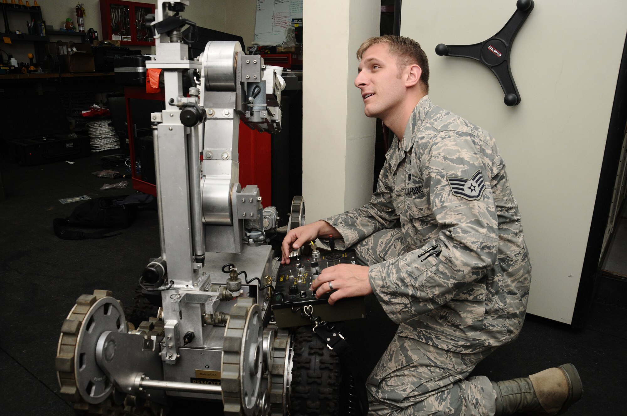 Staff Sgt. Joshua Hanna, 36th Civil Engineer Squadron explosive ordnance disposal journeyman, changes the battery on a F6A EOD robot on Andersen Air Force Base, Guam, April 11, 2013. Hanna was selected as the Pacific Air Forces’ 2012 Outstanding Airman of the Year in the Airman category for his superior performance while deployed and at home station. (U.S. Air Force photo by Airman 1st Class Mariah Haddenham/Released)