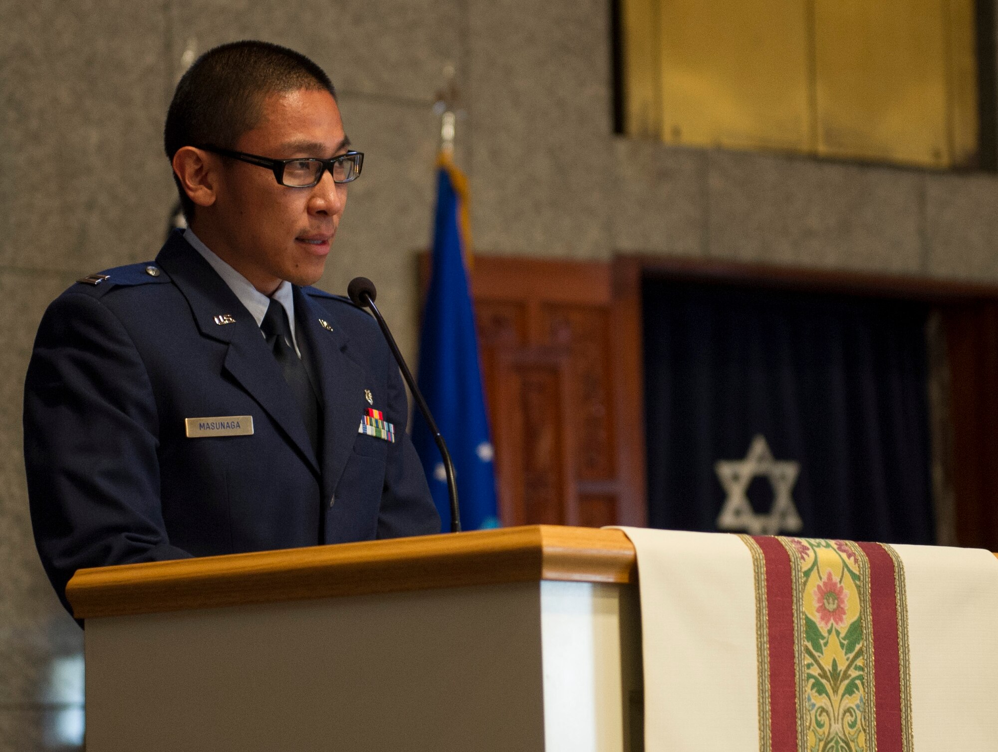 YOKOTA AIR BASE, Japan -- Capt. Evan Masunaga, 374th Dental Squadron, speaks to attendees of the 2013 Days of Remembrance Commemoration Ceremony at Yokota Air Base, Japan, April 11, 2013. Congress established the Days of Remembrance as the nation's annual commemoration of the Holocaust and created the United States Holocaust Memorial Museum as a permanent living memorial to the victims. Holocaust Remembrance week is April 7-14, 2013.  The theme designated by the USHMM for the 2013 observance is "Never Again:  Heeding the Warning Signs." (U.S. Air Force photo by Senior Airman Andrea Salazar/Released)