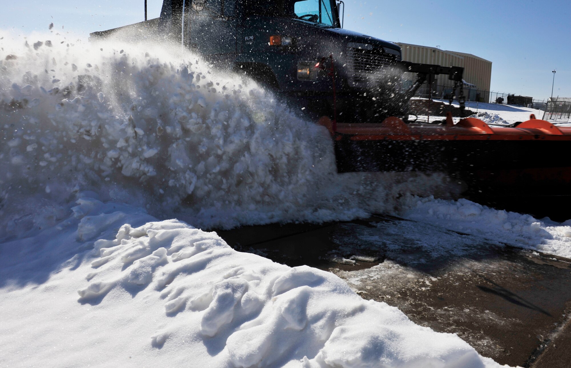 Airman 1st Class Jayce Yeager, 460th Civil Engineer Squadron heavy equipment operator, plows snow from the roads April 10, 2013, at Buckley Air Force Base, Colo. The 460th CES “Dirt Boys” worked 12-hour shifts to get the base ready for the next day.   (U.S. Air Force photo by Airman 1st Class Darryl Bolden Jr./Released)