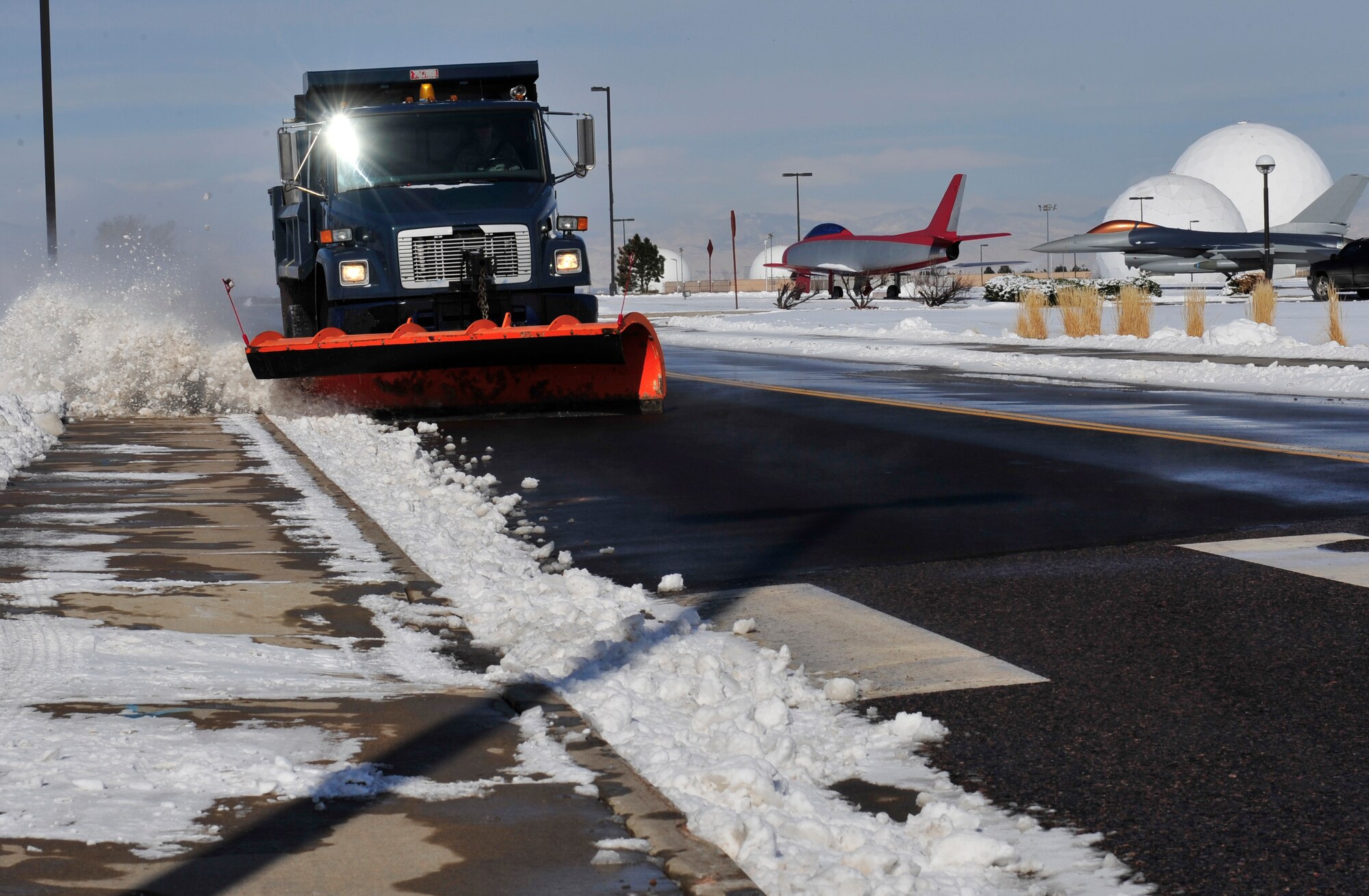 Airman 1st Class Jayce Yeager, 460th Civil Engineer Squadron heavy equipment operator, uses a snowplow to clear the road April 10, 2013, at Buckley Air Force Base, Colo.  The base received a reported 6 inches of snow during a 24-hour period. (U.S. Air Force photo by Airman 1st Class Darryl Bolden Jr./Released)