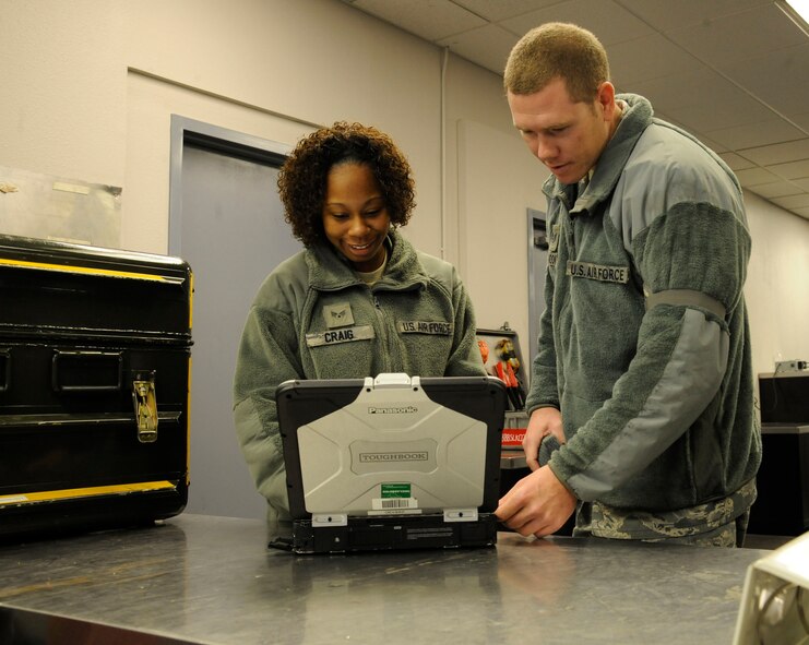 Airman 1st Class Valissia Craig, 2nd Aircraft Maintenance Squadron crew chief, looks over a technical order while checking out tools as Staff Sgt. Richard Moody, 372nd Training Squadron Detachment 5 B-52H Stratofortress Crew Chief instructor, observes on Barksdale Air Force Base, La., April 11, 2013. Craig is currently enrolled in a field training detachment class taught by Moody. The class teaches Airmen out of technical school, or new to the B-52 airframe, the specifics of their job. (U.S. Air Force photo/Airman 1st Class Andrew Moua)