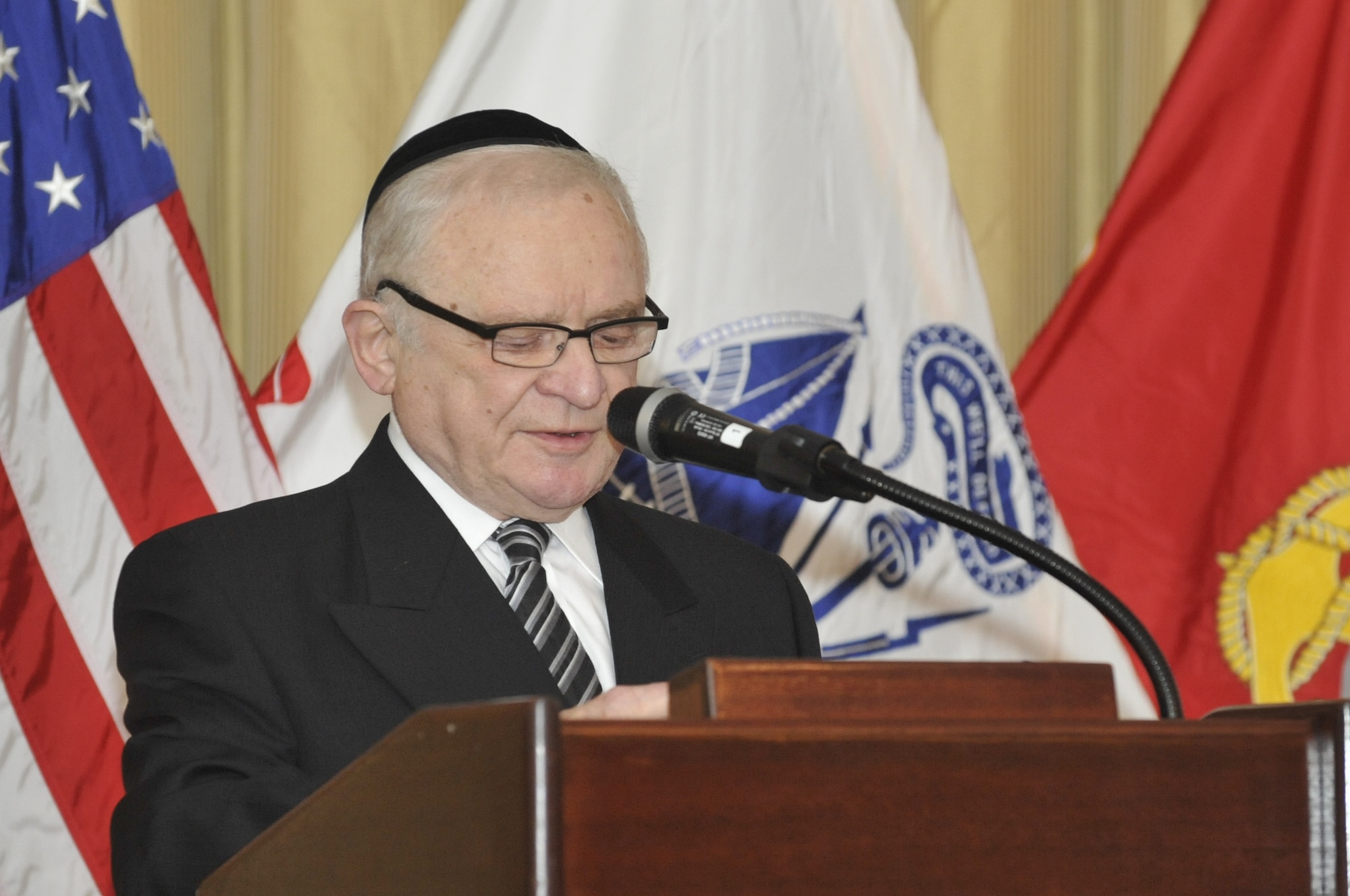 Joshua Brisk, one of the youngest Holocaust survivors of the Bistritz Ghetto, Auschwitz, Dachau, and other camps, emotionally talks about his experiences during the Holocaust during the 174th Infantry Brigade's Holocaust Remembrance Ceremony held in Tommy B’s Community Activities Cetner Joint Base McGuire-Dix-Lakehurst, N.J., April 8, 2013. He explained how grateful he was to the U.S. Army Soldiers who liberated Brisk April 29, 1945, and this is the first time that he has spoken to a military crowd since his liberation.  (U.S. Air Force photo by Wayne Russell/Released)
