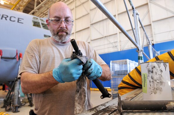 Jerome Estell, 560th Aircraft Maintenance Squadron mechanic, cleans and inspects C-130 aircraft parts. (U.S. Air Force photo by Tommie Horton)