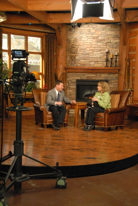 SSgt. Joe Davis speaks to Kathy Clark on camera April 10, 2013.  One weekend a month, Davis works from behind the camera as a broadcast journalist to tell the story of the Utah Air National Guard. During the rest of the month, Davis works in front of the camera as a co-host of Park City Television's "Mountain Morning Show."  (U.S. Air Force Photo by A1C Emily Hulse/Released)