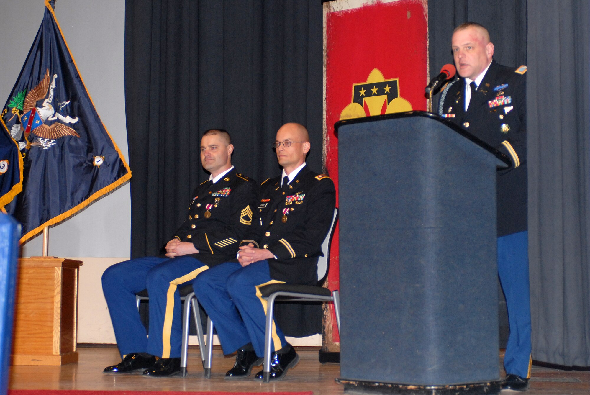 Col. Michael Shrout, 72nd Operations Brigade commander, honors two retiring service members, Sgt. 1st Class Brian Goodheart and Lt. Col. Andrew Decker, during a ceremony at Joint Base McGuire-Dix-Lakehurst, N.J., March 27, 2013. The service members received a folded U.S. flag and the retirement pin during the ceremony, signifying the last event of their military careers. (U.S. Army photo by Staff Sgt. Nicole Dykstra/Released)