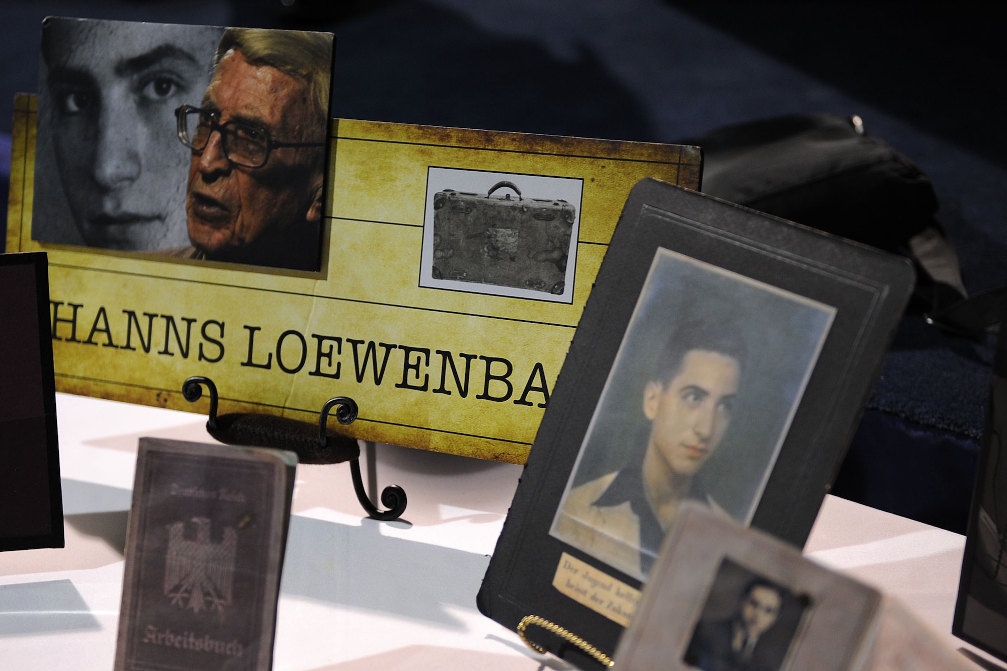 Pictures and memorabilia belonging to the late Hanns Loewenbach, a Holocaust survivor, are displayed during the Holocaust Days of Remembrance Commemoration at Langley Air Force Base, Va., April 8, 2013. Loewenach was a personal friend of Betsy Karotkin, the guest speaker during the commemoration, who narrated Loewenbach’s story. (U.S. Air Force photo by Senior Airman Brittany Paerschke-O’Brien/Released)