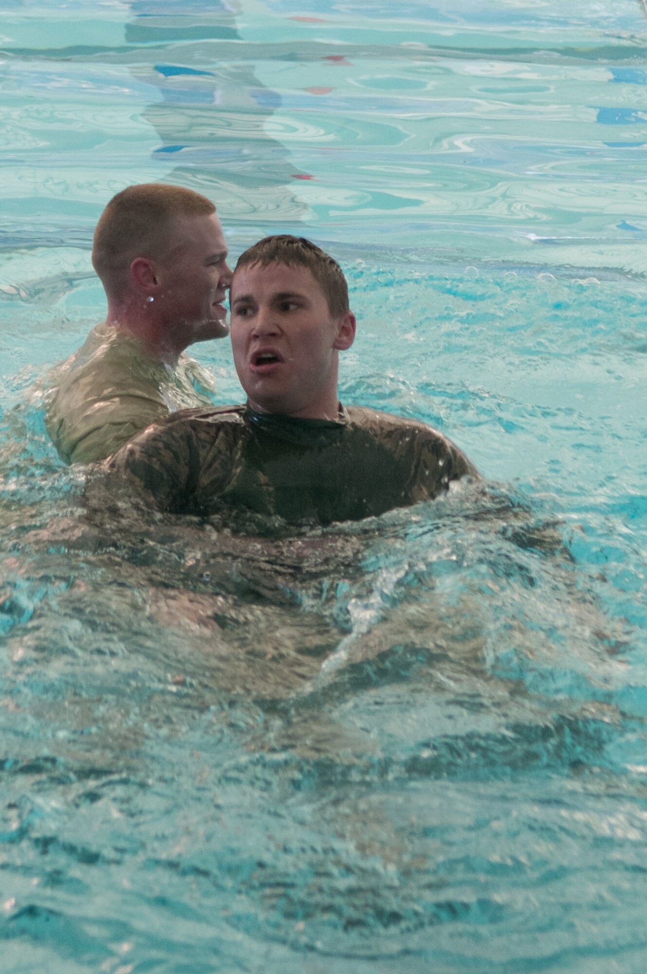 HANSCOM AIR FORCE BASE, Mass. – Airman 1st Class Tyler Repoli carries Senior Airman Talieson during the  buddy survival swim at the base pool April 3. The swim was part of Warrior Day activities, where total of 40 military and civilian members participated.  (U.S. Air Force photo by Rick Berry)