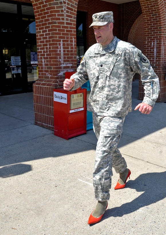 U.S. Army Lt. Col. Doug Pietrowski, 7th Sustainment Brigade deputy commanding officer, wears a pair of women’s high heels while participating in the Walk a Mile in Her Shoes event at Fort Eustis, Va., April, 10, 2013. The event is one of many that are meant to bring awareness to sexual assault and gender violence. (U.S. Air Force photo by Staff Sgt. Wesley Farnsworth/Released)