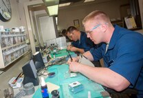 U.S. Air Force Airman 1st Class Justin Shaw, 23d Aerospace Medicine Squadron dental laboratory technician, and Tech. Sgt. Matt Fitzgerald, 23d AMDS dental laboratory NCO in charge, work on dental prosthetics and appliances at Moody Air Force Base, Ga., April 9, 2013. Shaw and Fitzgerald are the only two dental laboratory technicians on Moody. (U.S. Air Force photo by Senior Airman Jarrod Grammel/Released)
