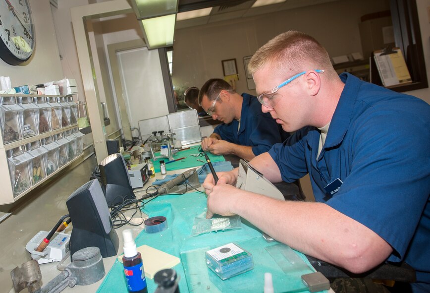 U.S. Air Force Airman 1st Class Justin Shaw, 23d Aerospace Medicine Squadron dental laboratory technician, and Tech. Sgt. Matt Fitzgerald, 23d AMDS dental laboratory NCO in charge, work on dental prosthetics and appliances at Moody Air Force Base, Ga., April 9, 2013. Shaw and Fitzgerald are the only two dental laboratory technicians on Moody. (U.S. Air Force photo by Senior Airman Jarrod Grammel/Released)
