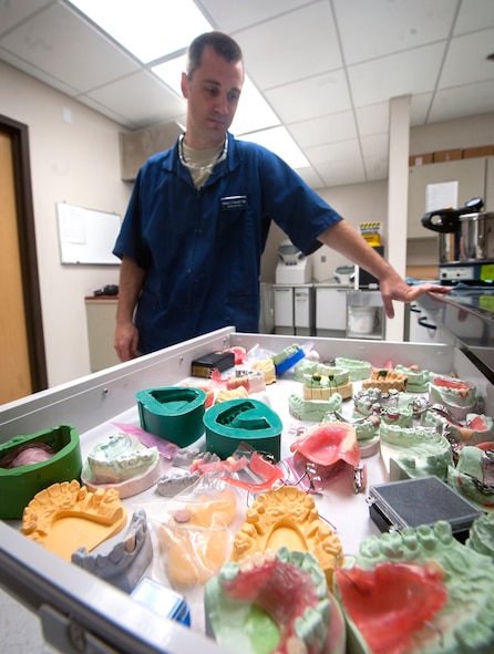 U.S. Air Force Tech. Sgt. Matt Fitzgerald, 23d Aerospace Medicine Squadron dental laboratory NCO in charge, opens a drawer full of training projects at Moody Air Force Base, Ga., April 9, 2013. The dental laboratory is responsible for making dental prosthetics and appliances, such as retainers, crowns and mouth guards for the base. (U.S. Air Force photo by Senior Airman Jarrod Grammel/Released)