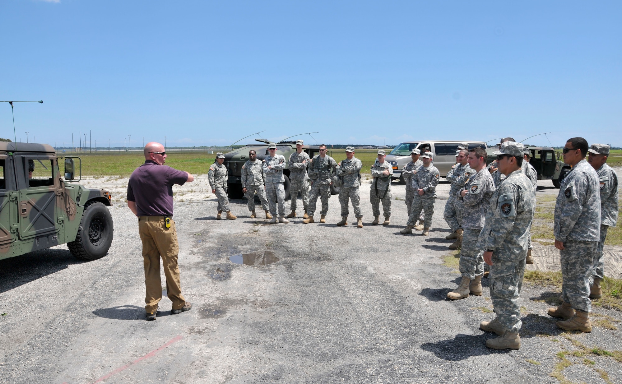 Michael Clay (left), an Army consultant who specializes in counter improvised explosive device training, speaks with soldiers from the Army’s 260th Military Intelligence Battalion Alpha Company out of Miami, Fla., at Homestead Air Reserve Base, Fla., April 6. The soldiers set up camp at the Homestead ARB’s bivouac site to conduct intelligence mission essential task list drills, tactical convoy operations training, enemy contact training, training for near and far ambushes, counter improvised explosive device training, generator training, vehicle recovery operations training, and driver lane training.  (U.S. Air Force photo/Senior Airman Nicholas Caceres)