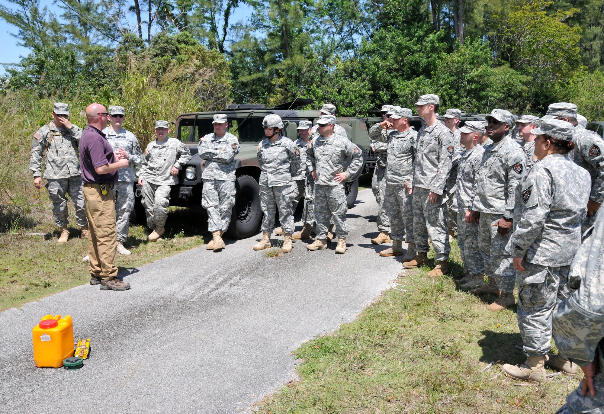 Michael Clay (left), an Army consultant who specializes in counter improvised explosive device training, speaks with soldiers from the Army’s 260th Military Intelligence Battalion Alpha Company out of Miami, Fla., at Homestead Air Reserve Base, Fla., April 6. The soldiers set up camp at the Homestead ARB’s bivouac site to conduct intelligence mission essential task list drills, tactical convoy operations training, enemy contact training, training for near and far ambushes, counter improvised explosive device training, generator training, vehicle recovery operations training, and driver lane training.  (U.S. Air Force photo/Senior Airman Nicholas Caceres)