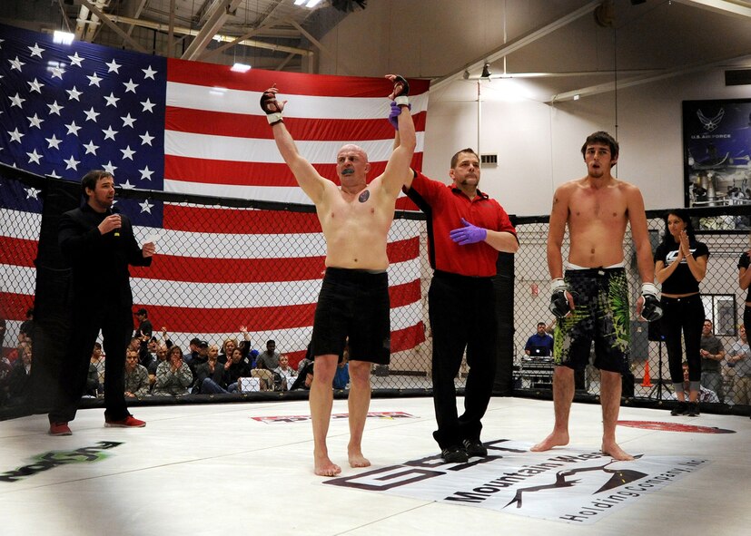 Mixed Martial Artist Travis Rourke’s hand is raised by referee Bret Hamlin after Rourke’s victory April 5 at Malmstrom Air Force Base. Rourke was a former Airman once assigned to Malmstrom. (U.S. Air Force photo/Staff Sgt. R.J. Biermann)