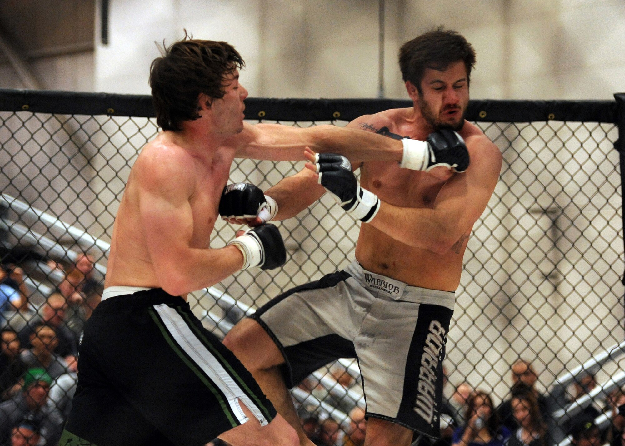 Mixed Martial Artist Ryan McCracken lands a left hook to the chin of opponent Stewart Langdon during an MMA fight April 5 at Malmstrom Air Force Base, Mont. McCracken won the matchup. (U.S. Air Force photo/Staff Sgt. R.J. Biermann)
