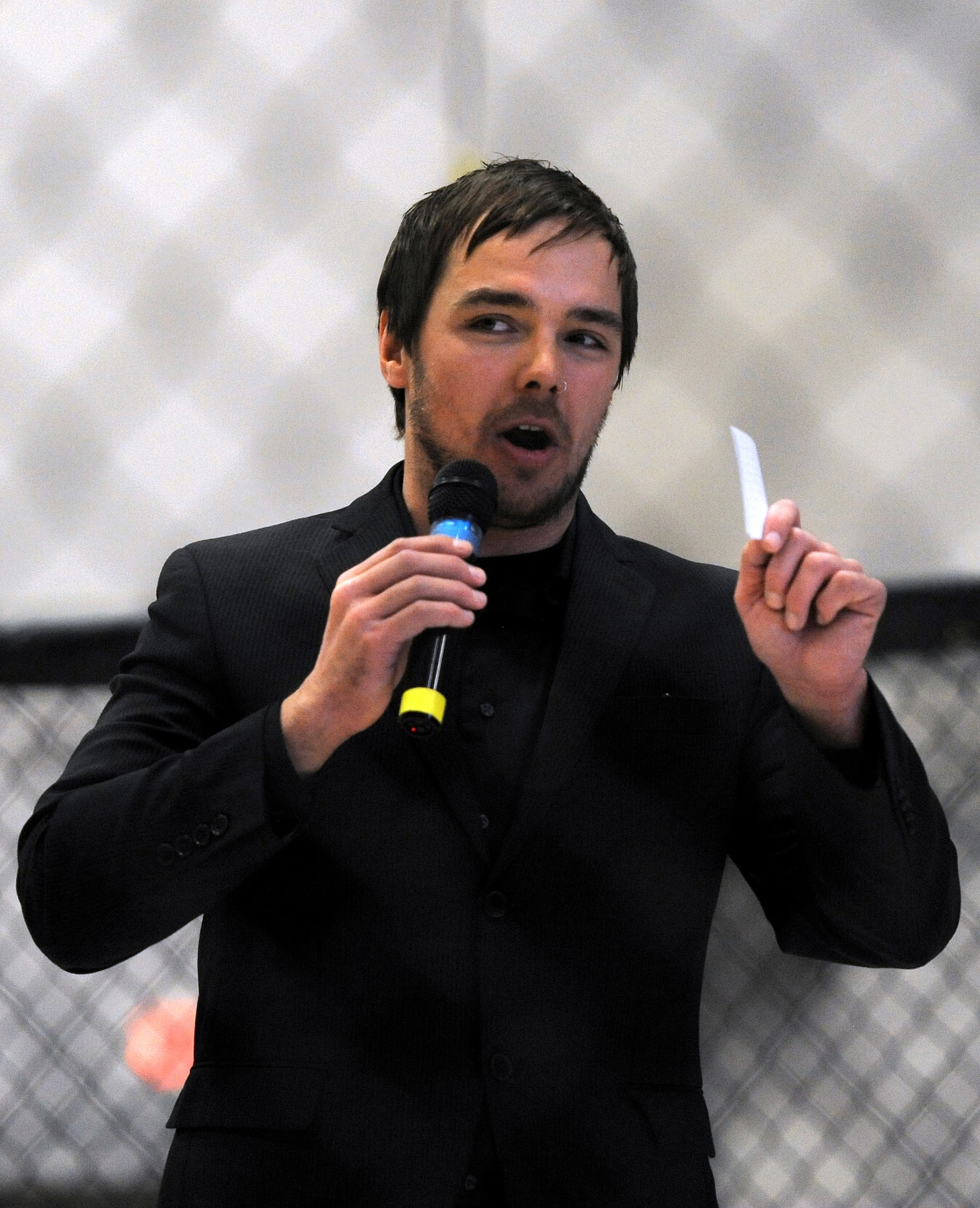Bob Sather, 221 Industries announcer, welcomes Mixed Martial Arts fans to 221’s first Fight For the Troops event at Malmstrom Air Force Base, Mont., on April 5. The event included six bouts, including an Intense Cage Fighting 145-pound championship rematch between Sky Folsom and Colin Lee. (U.S. Air Force photo/Staff Sgt. R.J. Biermann)