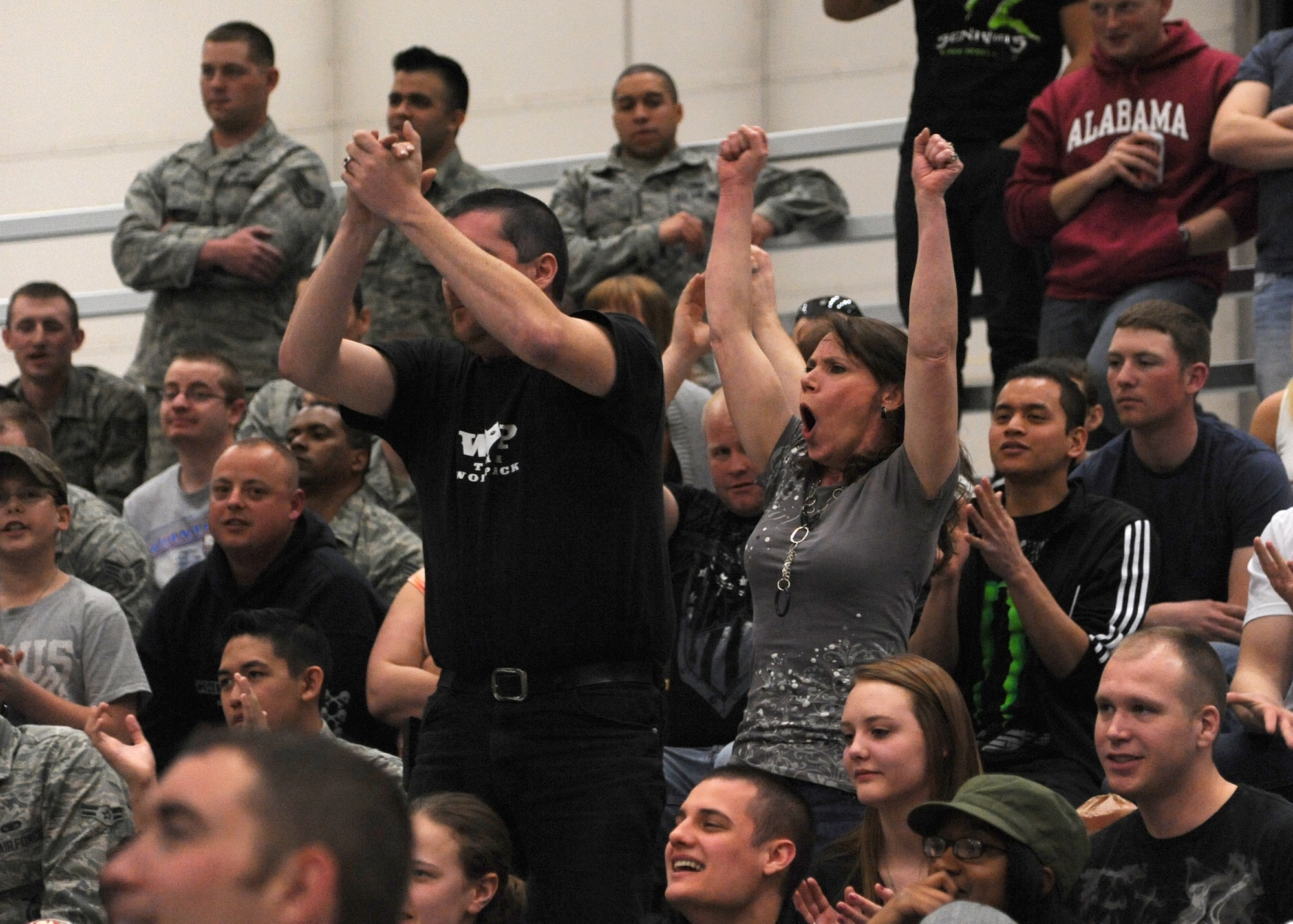 Team Malmstrom members applaud mix martial artists at the 3-Bay Hangar during a Fight for the Troops event on April 5. The first of its kind event brought 1,100 attendees. (U.S. Air Force photo/Airman 1st Class Katrina Heikkinen)
