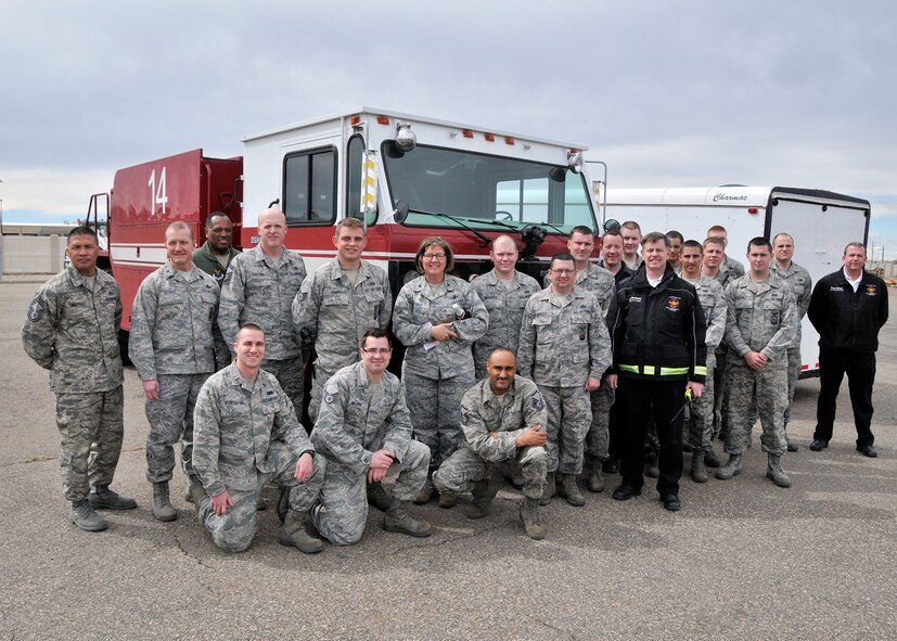 Members of Malmstrom’s fire department pose in front of their new P-19 Aircraft Rescue Fire Fighting truck named Clifford, following a christening ceremony April 5.  This vehicle can carry 1,000 gallons of water and 110 gallons of firefighting foam; this doubles Malmstrom capacity from a current capacity of 500 gallons of water and 50 gallons of foam.  This particular model of the P-19 AARF can be used for aircraft or building fires, and Malmstrom’s fire department plans to use it this summer to assist with putting out wild fires.  (U.S. Air Force photo/John Turner)