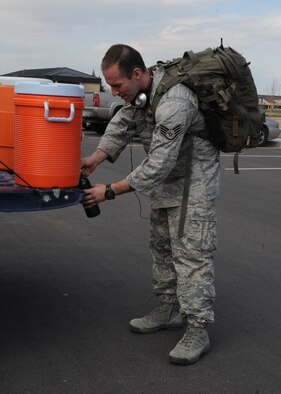 Staff Sgt. Maxwell Thompson, 341st Security Support Squadron training instructor, fills up his water bottle after completing the ruck march at the Grizzly Bend on April 3. Thompson was the fourth Airman to finish the march of more than 100 members of Team Malmstrom. (U.S. Air Force photo/Airman 1st Class Katrina Heikkinen)