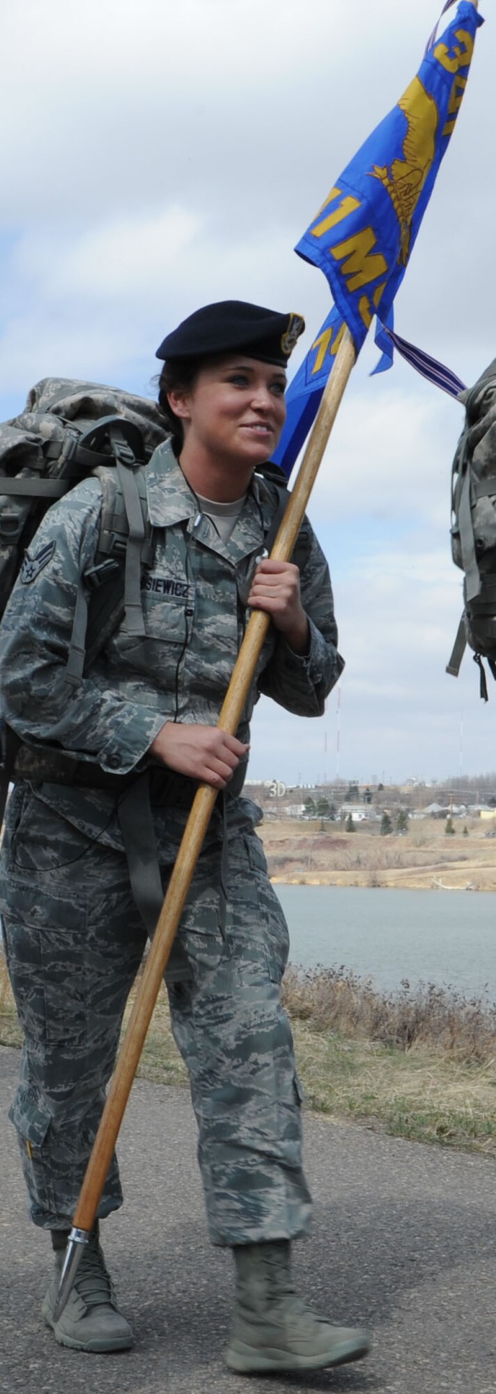 Senior Airman Mary Tarasiewicz, 741st Missile Security Forces Squadron member, holds the flag from her squadron during the 8.3-mile ruck march on Rivers Edge Trail in Great Falls. More than 100 members of Team Malmstrom participated in Malmstrom’s largest ruck march. (U.S. Air Force photo/Airman 1st Class Katrina Heikkinen) 