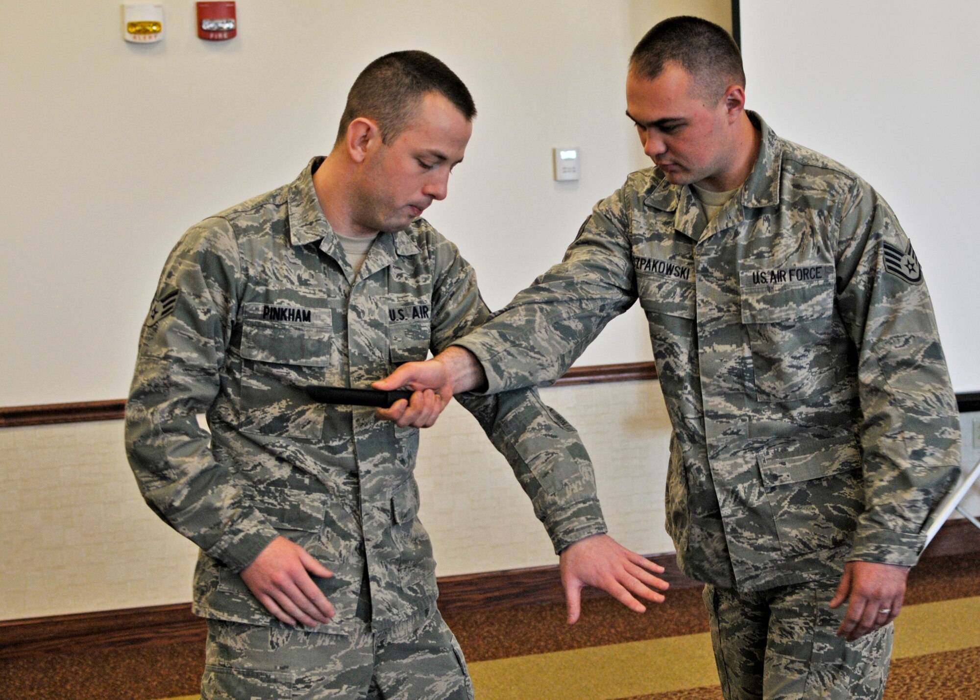 As part of the 914th Airlift Wing's Sexual Assault Awareness Month training, 914th Logistics Readiness Squadron members Senior Airman Dillon Pinkham and Staff Sgt. Lyle Szpakowski give a demonstration of how to defend against a knife attack during a luncheon held at the Community Activity Center, April 8, 2013, Niagara Falls Air Reserve Station, NY. This training was one of several SAAM events held at the NFARS. (U.S. Air Force photo by Tech. Sgt. Joseph McKee) 