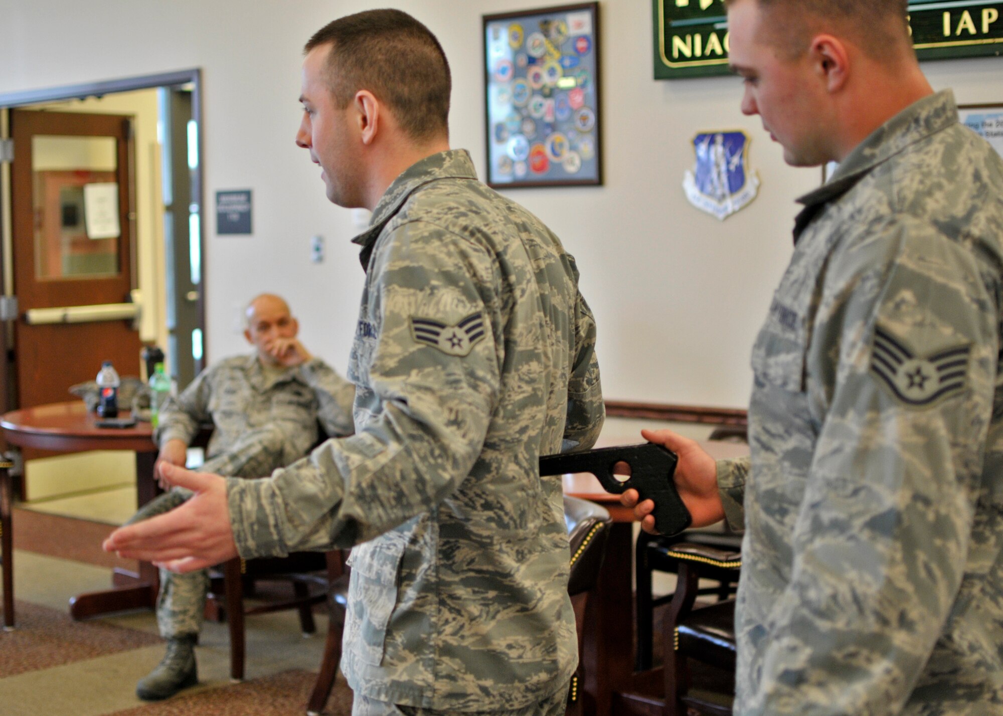 As part of the 914th Airlift Wing's Sexual Assault Awareness Month training, 914th Logistics Readiness Squadron members Senior Airman Dillon Pinkham and Staff Sgt. Lyle Szpakowski give a demonstration of how to defend against an armed attacker during a luncheon held at the Community Activity Center, April 8, 2013, Niagara Falls Air Reserve Station, NY. This training was one of several SAAM events held at the NFARS. (U.S. Air Force photo by Tech. Sgt. Joseph McKee) 