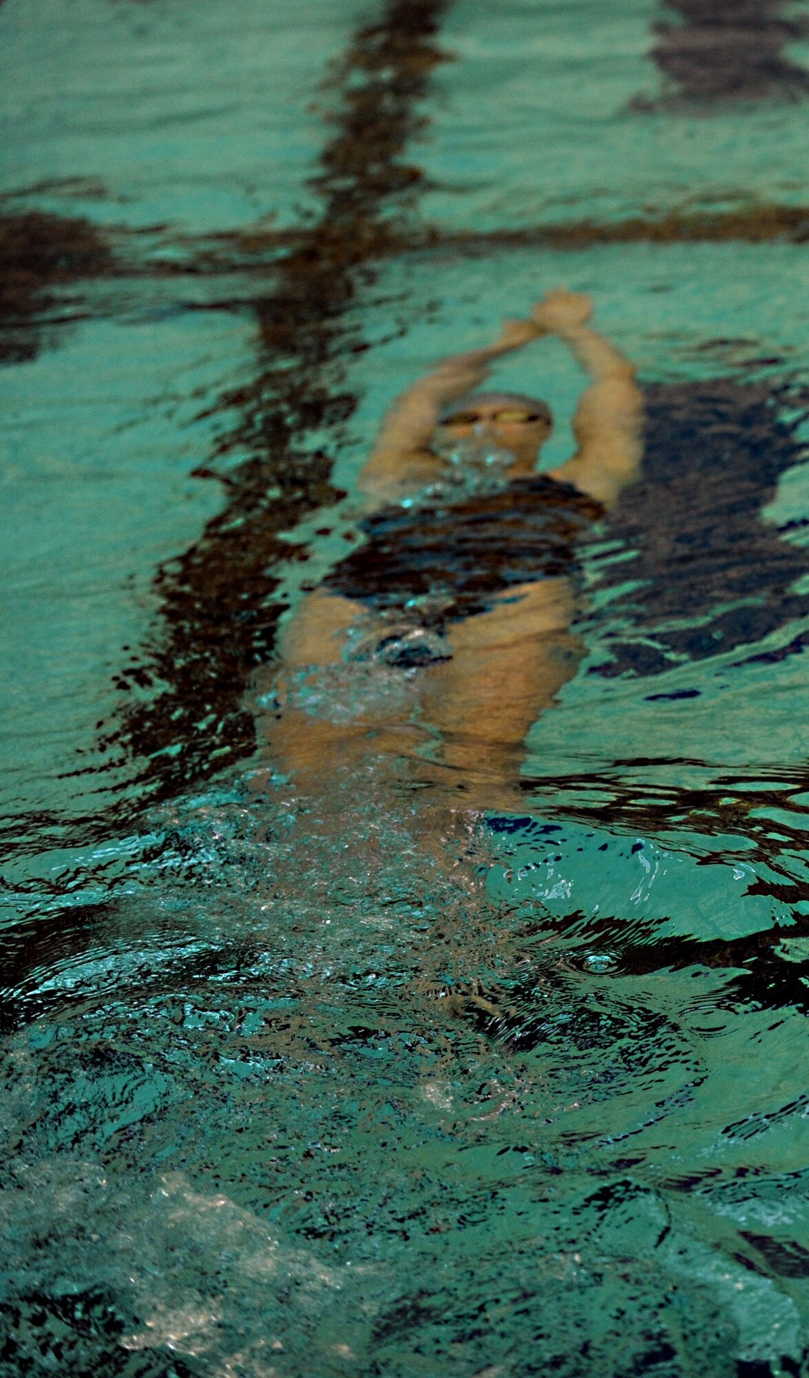 Cait Horner, daughter of Lt. Col. Edward Horner, swims underwater at the Brittingham-Midtown Aquatics Center in Newport News, Va., April 9, 2013. Cait said competitive swimming has helped her remain resilient throughout all the moves and deployments that come with being a military child. (U.S. Air Force photo by Staff Sgt. Jarad A. Denton/Released) 