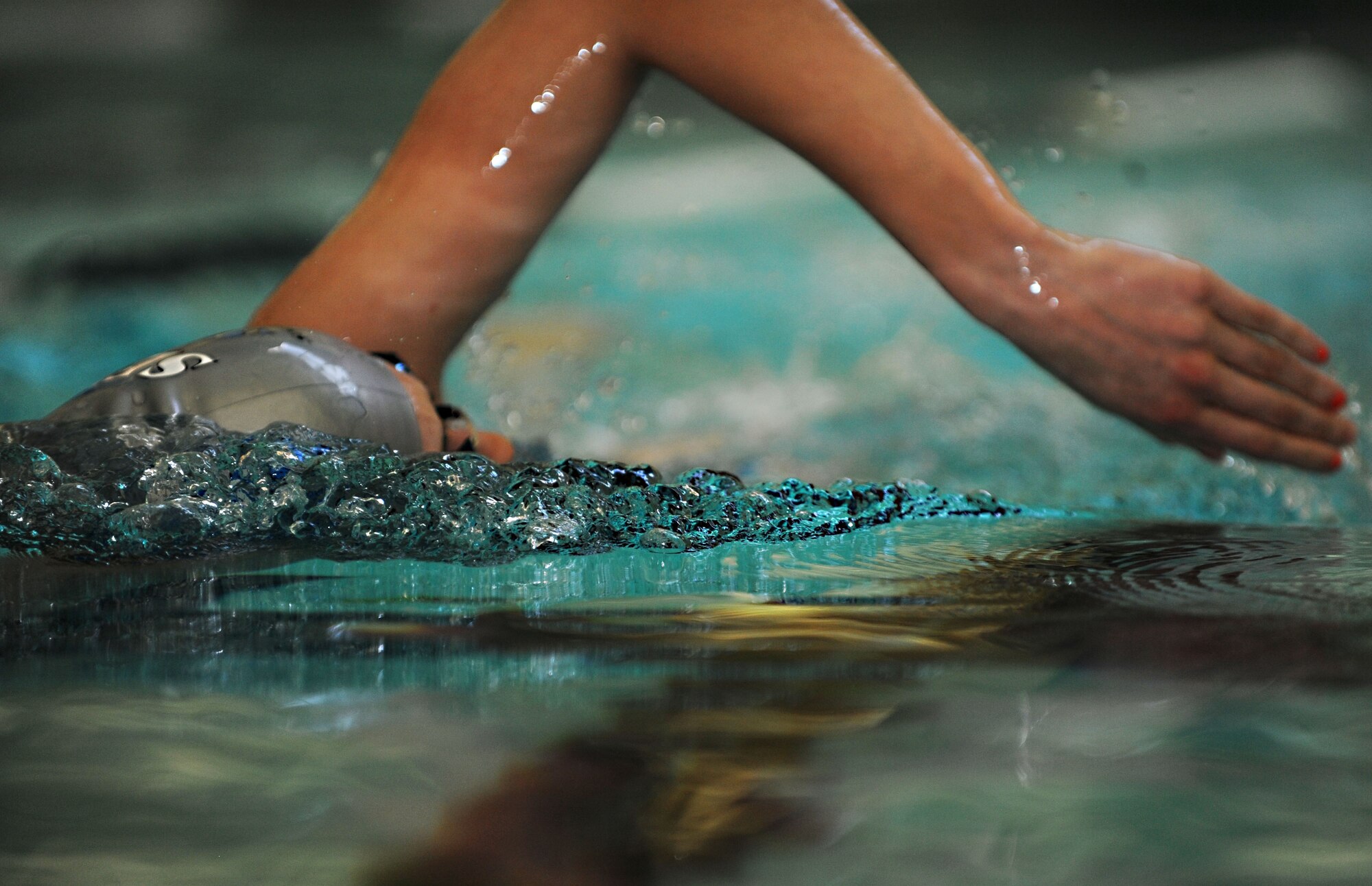 Cait Horner, 16-year-old daughter of Lt. Col. Edward Horner, cuts through the water at the Brittingham-Midtown Aquatics Center in Newport News, Va., April 9, 2013. Recently, Cait was named as one of the Top 5 finalists in the 2013 Military Child of the Year competition. (U.S. Air Force photo by Staff Sgt. Jarad A. Denton/Released)