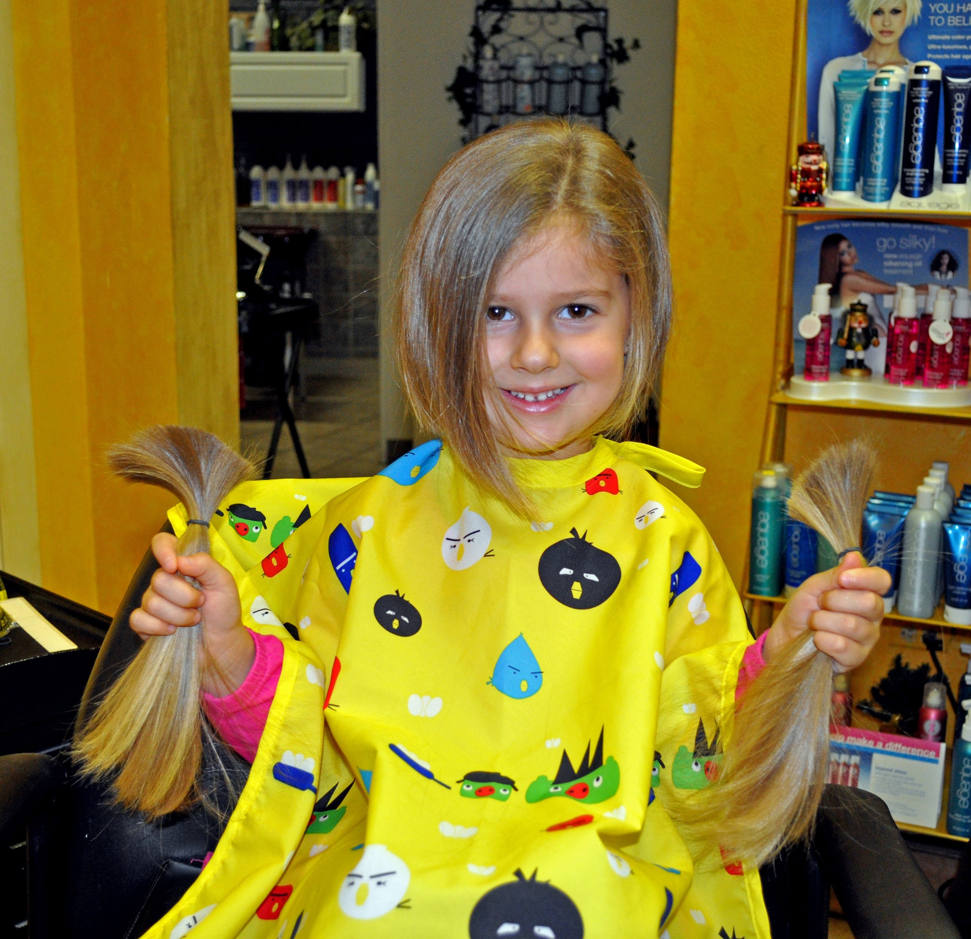 Elizabeth "Ellie" DeSmith holds her hair after getting 10 inches cut for a
donation to Locks of Love. Her donation will be made into hairpieces for
children under 21 who are suffering from long-term medical hair loss.
 (Maj. Brad DeSmith  /Courtesy)