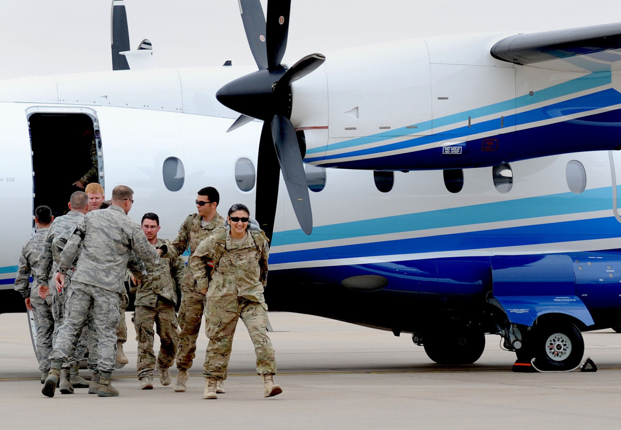 Air Commandos returning from deployment were welcomed home by 27th Special Operations Wing leadership, family members and friends during Operation Homecoming at Cannon Air Force Base, N.M., April 9, 2013. Operation Homecoming is a monthly event that reunites Cannon's Air Commandos with their loved ones. (U.S. Air Force photo/Airman 1st Class Ericka Engblom)