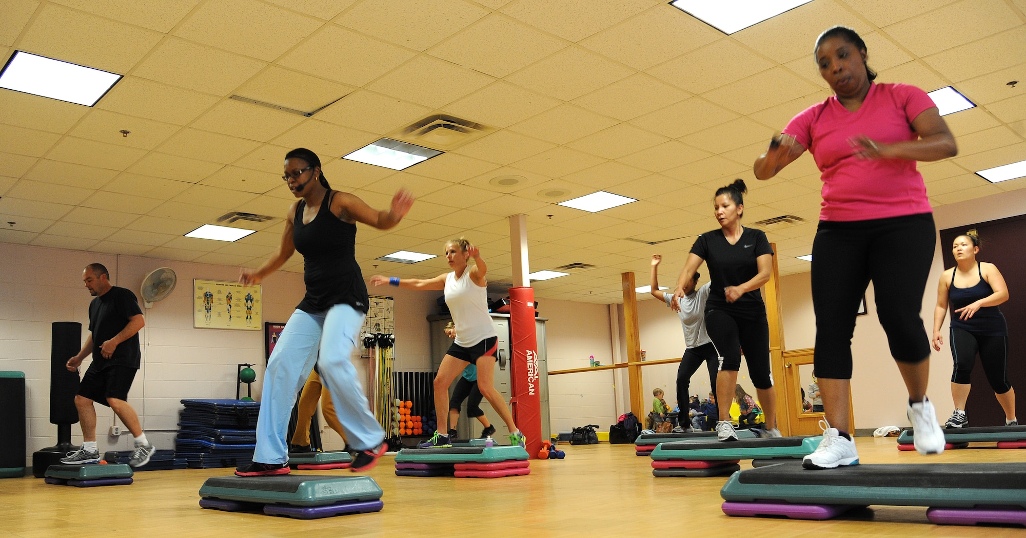 Fitness instructor Mona leads a group of Team Pete personnel in a Triple Threat class April 9 at the Peterson Air Force Base fitness and sports center. The Triple Threat class is a combination of step, kickboxing and tone in motion exercises. The Peterson Air Force Base fitness and sports center offers a variety of aerobics classes each week to help Team Pete personnel maintain an active and healthy lifestyle (U.S. Air Force photo/Staff Sgt. J. Aaron Breeden)