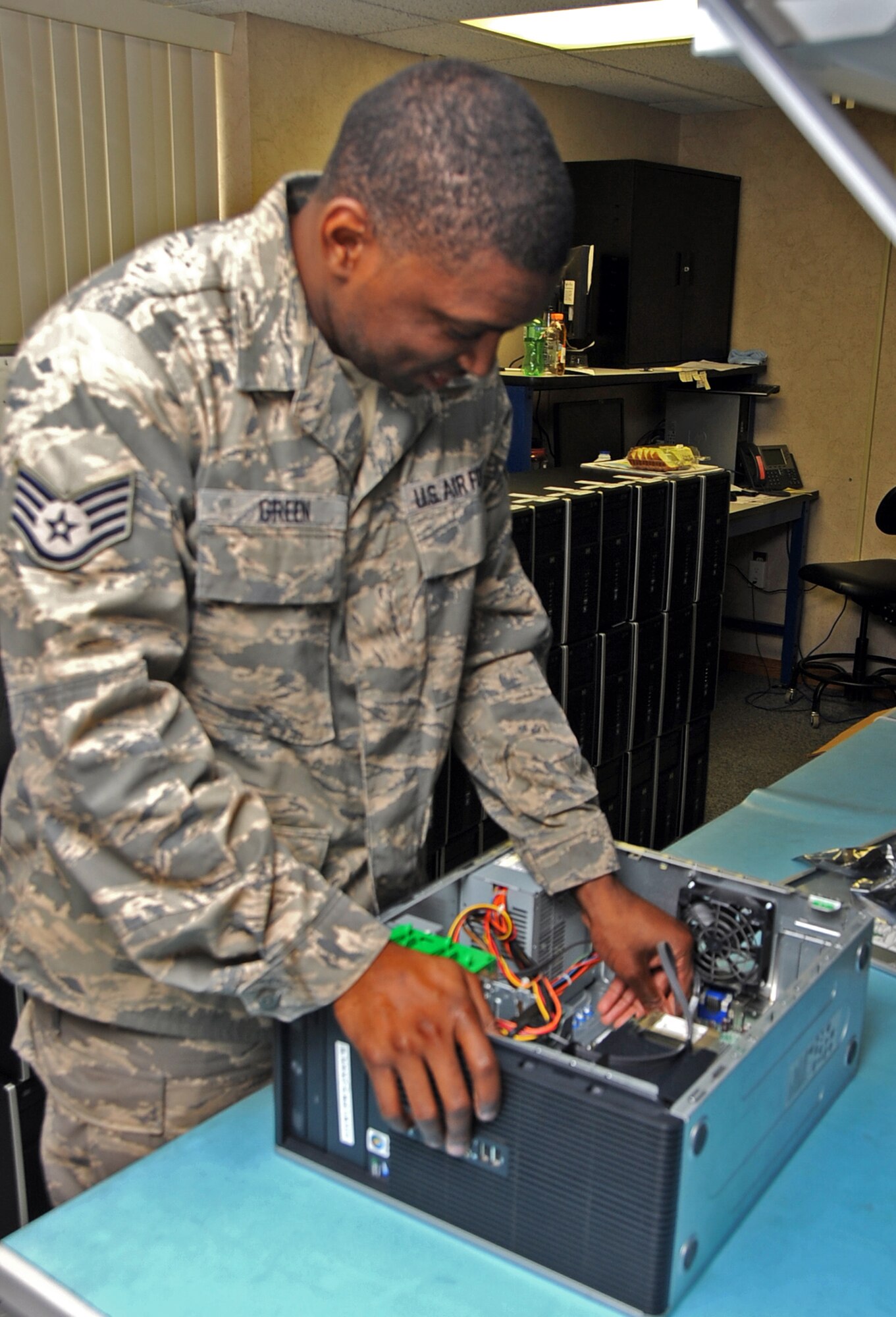Staff Sgt Gregory Green, 2nd Communications Squadron Client Support Systems, removes a computer's memory card on Barksdale Air Force Base, La., April 10, 2013. CSS technicians provide support for more than 9,000 computers for base personnel. (U.S. Air Force photo/Staff Sgt. Jason McCasland)