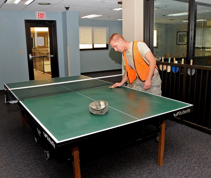 Airman First Class Jacob Wilcox, 2nd Logistics Readiness Squadron Vehicle Maintenance, cleans a ping-pong table in the dorms during Bay Orderly duty on Barksdale Air Force Base, La., April 9, 2013. Bay orderlies are responsible for many things around the dorms and each Airman works in the dorm assigned to their respective squadron. (U.S. Air Force photo/Airman 1st Class Benjamin Raughton)